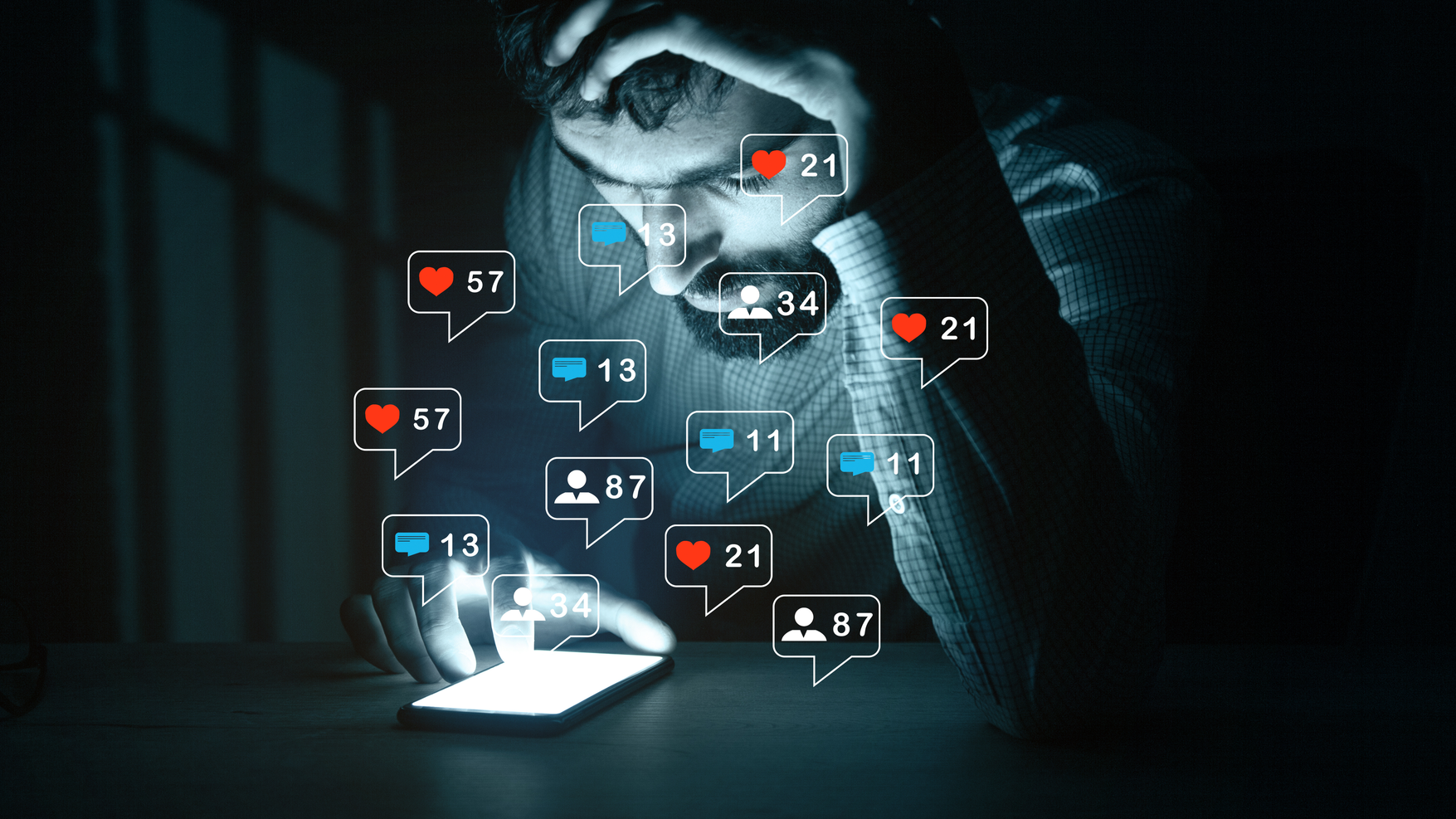 Man posting to social media in the dark