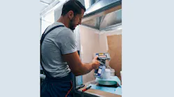 Painter mixing paint on scale