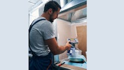 Painter mixing paint on scale Painter mixing paint on scale