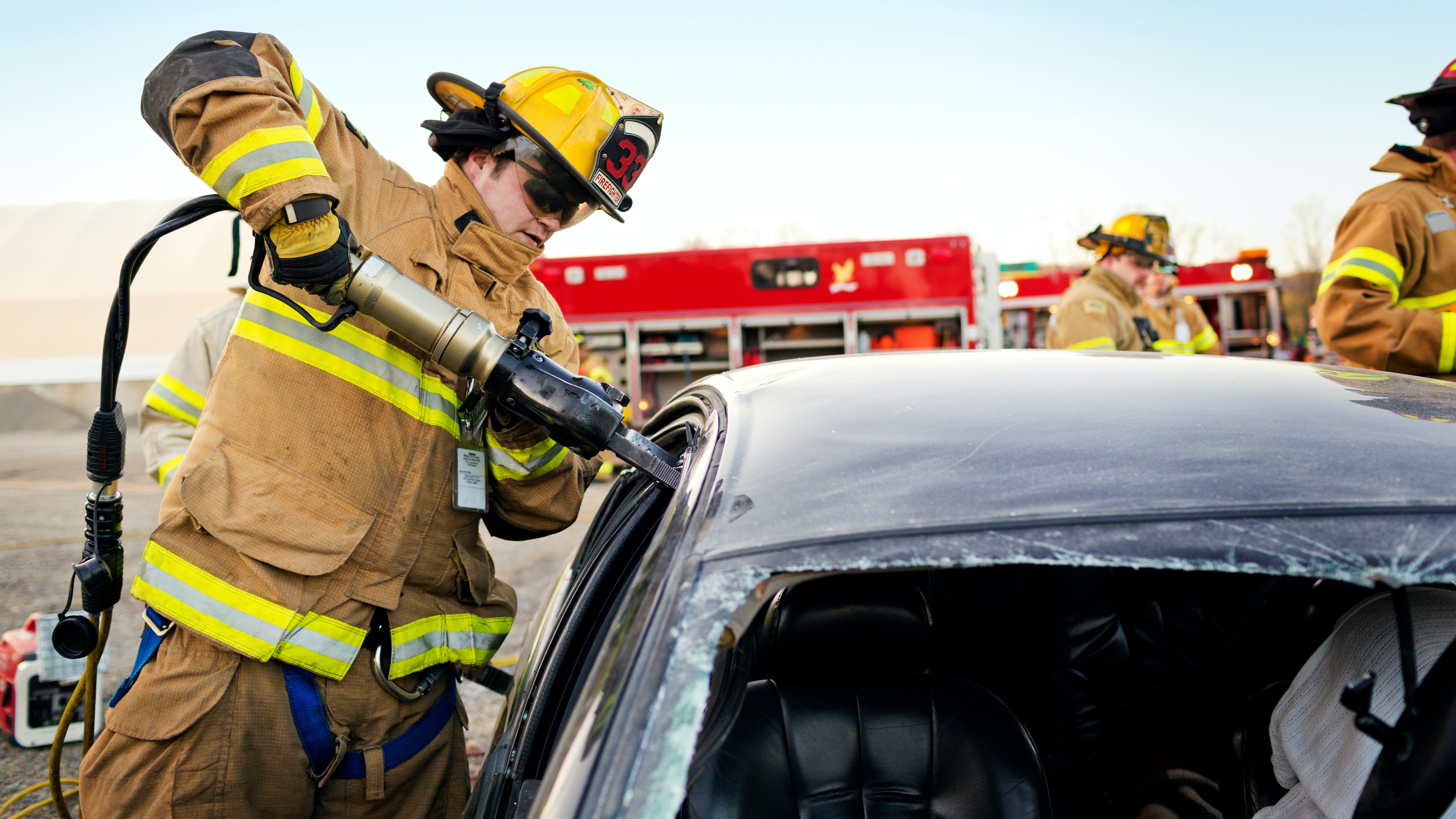 Firefighter using extrication tool
