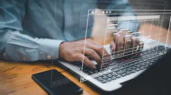 Man crunching numbers at laptop