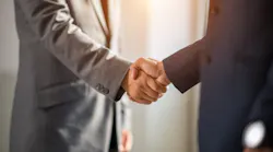 Two businessmen shake hands