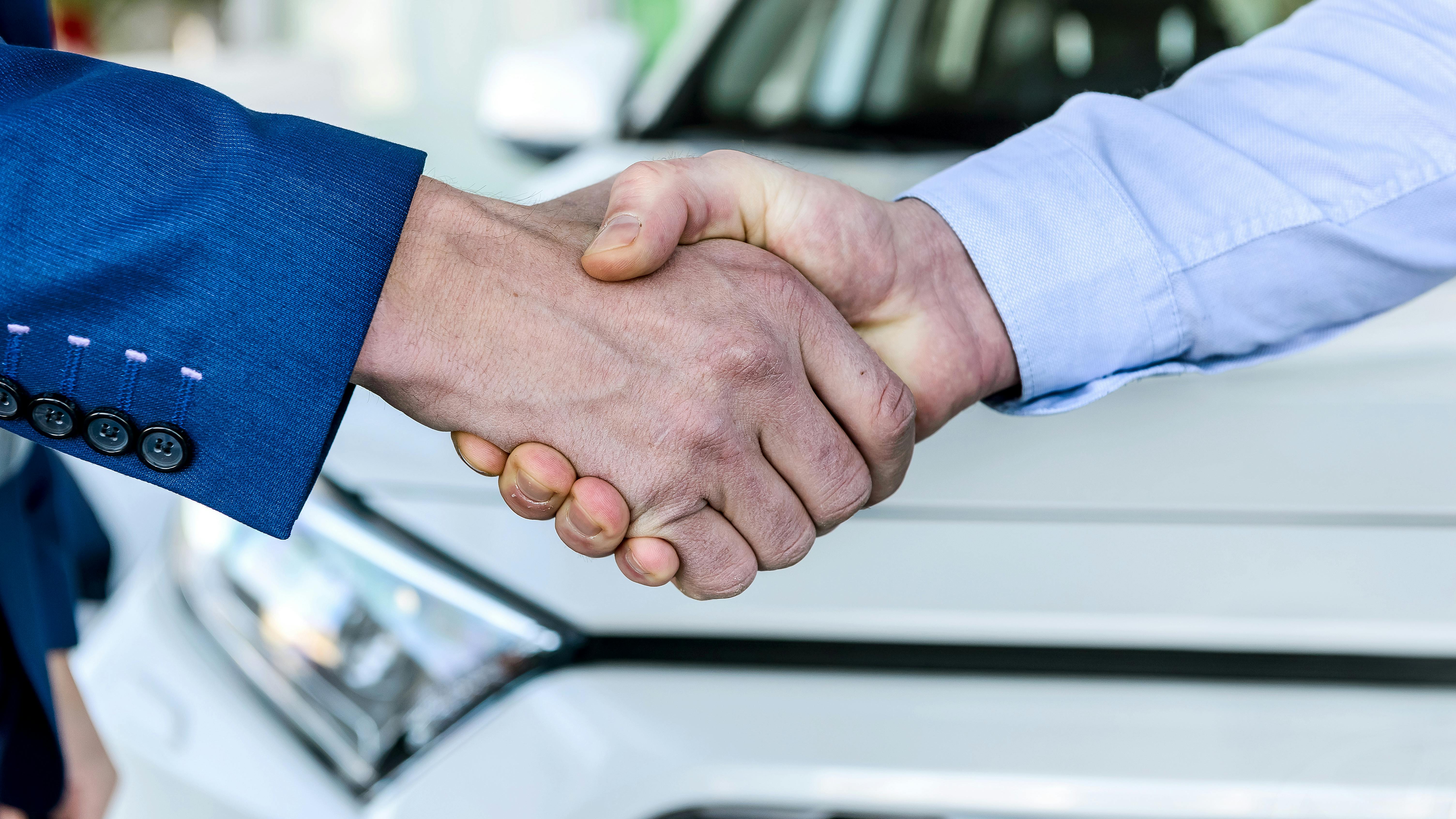 6595d21675c28d001e2fed3d Handshake With Car Adobestock 286273224