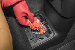 Special “Class 0” gloves are used to disable the battery disconnect in an electric vehicle. Special “Class 0” gloves are used to disable the battery disconnect in an electric vehicle.