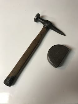 A hammer and dolly used for body repairs. A hammer and dolly used for body repairs.