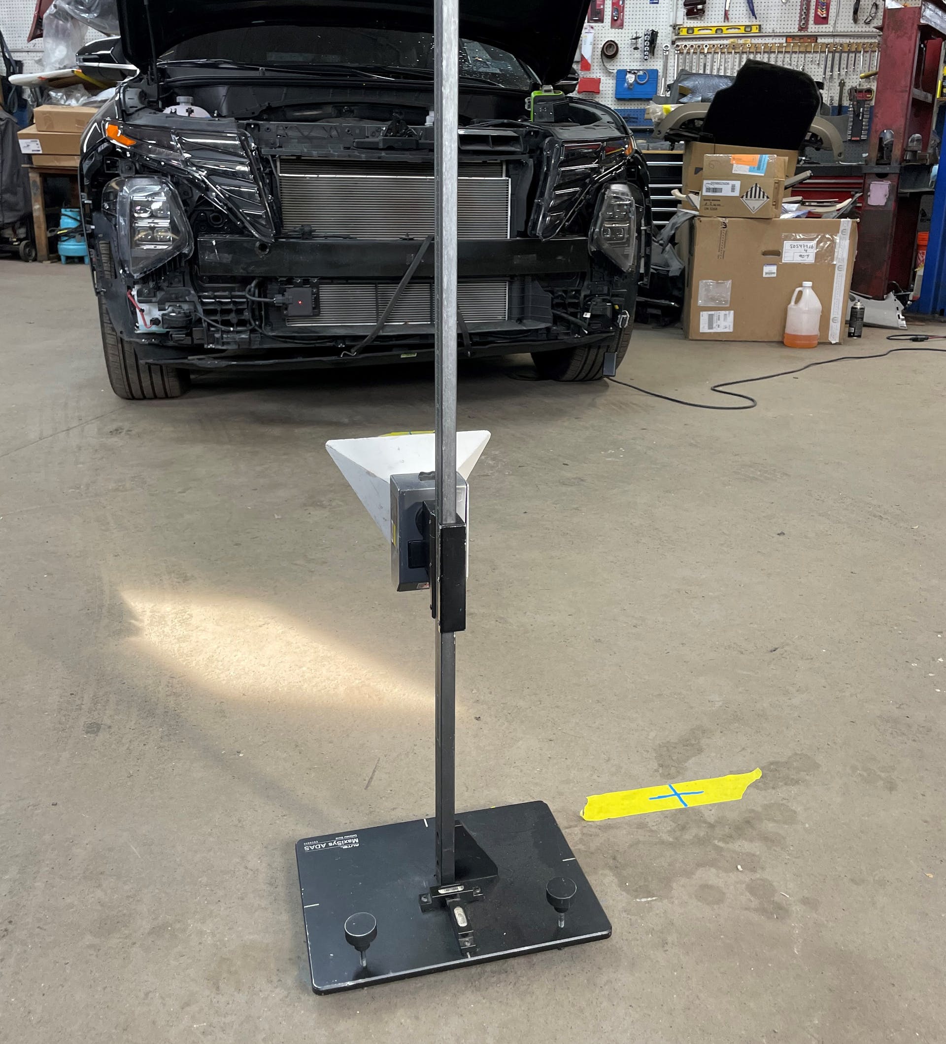 FIG5- The fifth calibration step is to place the target on the corner of the grid facing the radar unit and moving the target cone down to a point where the cone&rsquo;s internal laser hits the center of the radar housing.