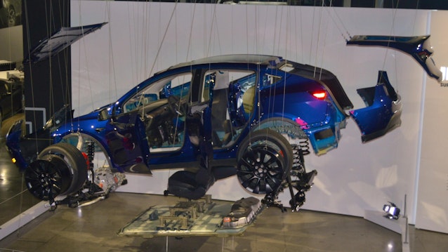 This exploded diagram 2023 Tesla Model Y is part of the 'Inside Tesla' exhibit at The Petersen Automotive Museum.