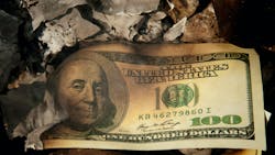 US $100 bill in fire