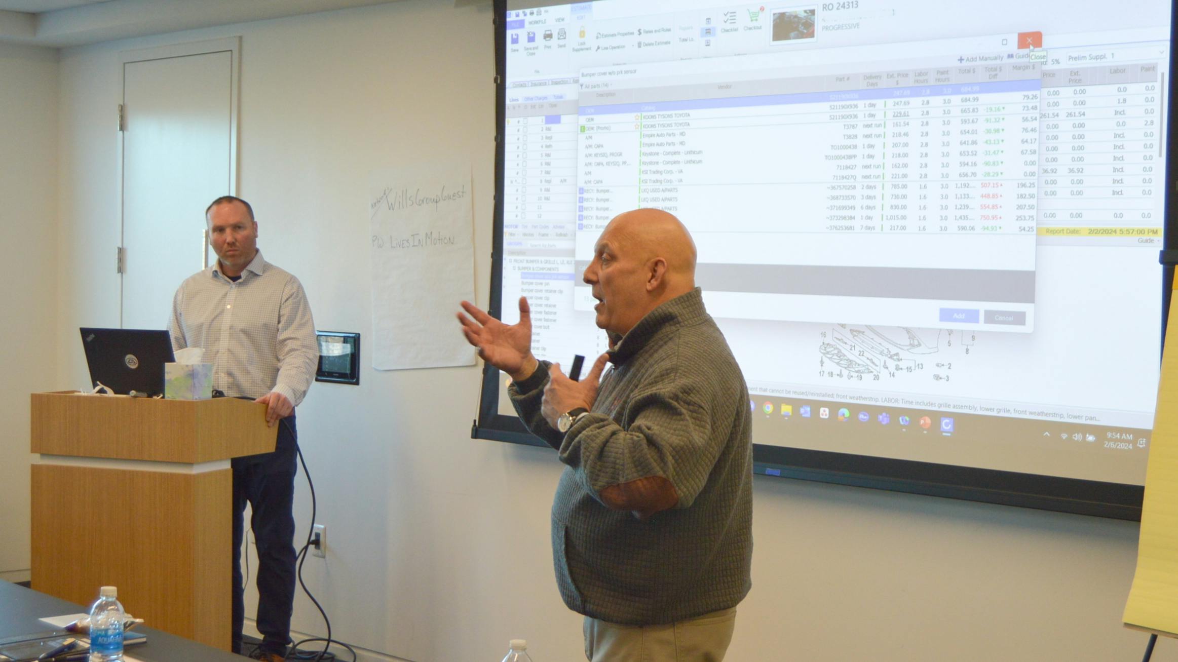 Kris Burton (left), owner of Rosslyn Auto Body, Alexandria, Virginia, and Mike Anderson, Collision Advice, go over a sample estimate.
