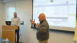 Kris Burton (left), owner of Rosslyn Auto Body, Alexandria, Virginia, and Mike Anderson, Collision Advice, go over a sample estimate.