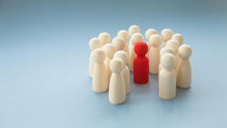 A single individual who is different to the rest standing out from a crowd