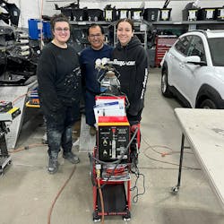 Julio Ruales, a technician at Caliber Collision, stands behind Polyvance's 8202 Nitro-Fuzer, flanked by TAP apprentices Jessica Dailey (left) and Emily Alberghini (right). Julio Ruales, a technician at Caliber Collision, stands behind Polyvance's 8202 Nitro-Fuzer, flanked by TAP apprentices Jessica Dailey (left) and Emily Alberghini (right).