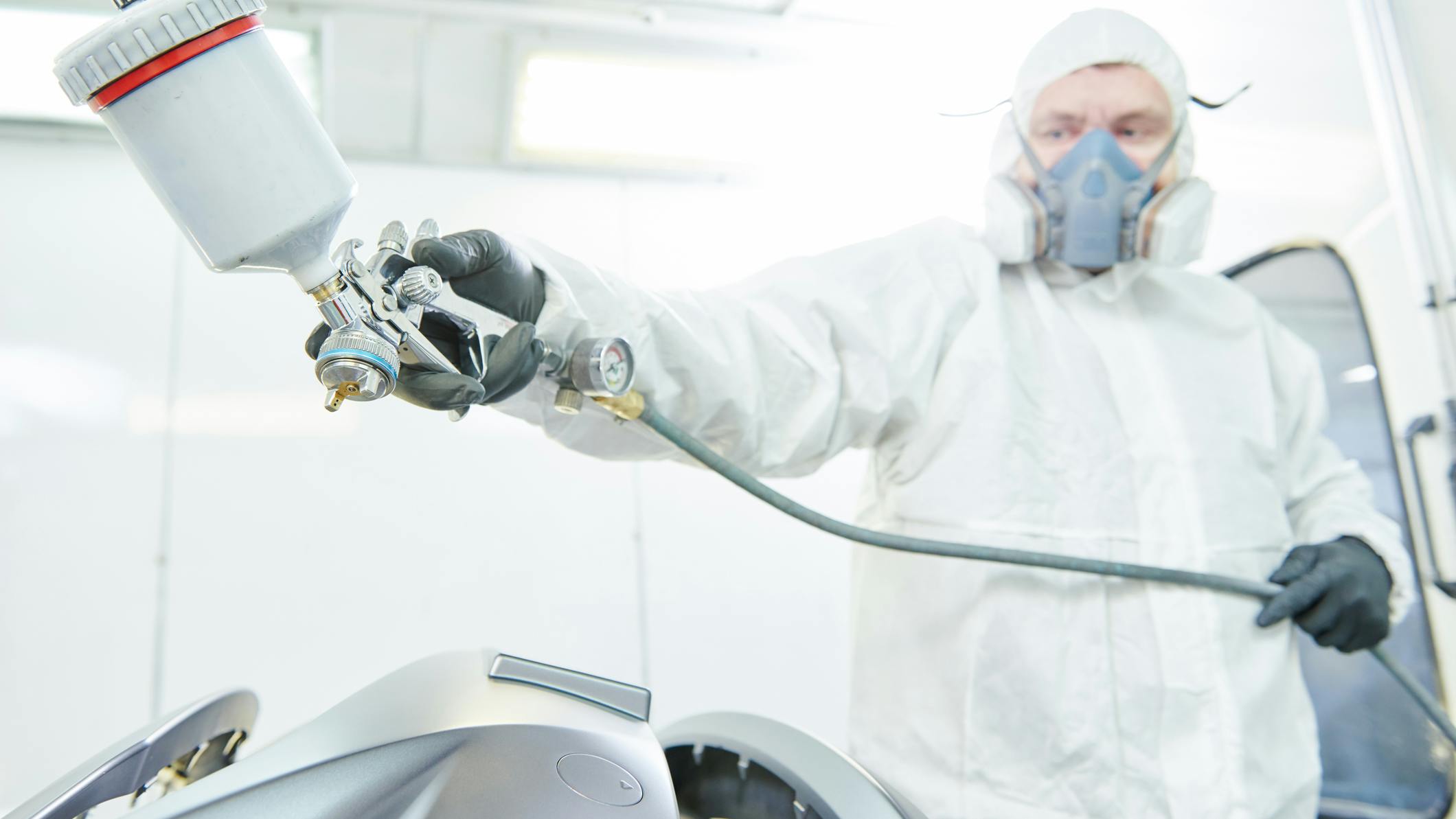 Spraying paint in booth