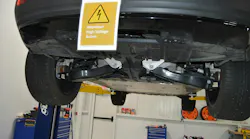 As this placard at I-CAR's Chicago Technical Center shows, it's critical to use a placard for EVs that have not had their battery disabled. A lift table is needed for this type of two-post lift to handle the battery.