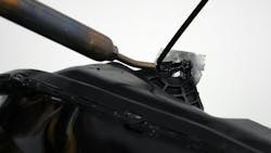 A closeup of the nitrogen welder being used to repair a headlight-mounting tab. A closeup of the nitrogen welder being used to repair a headlight-mounting tab.