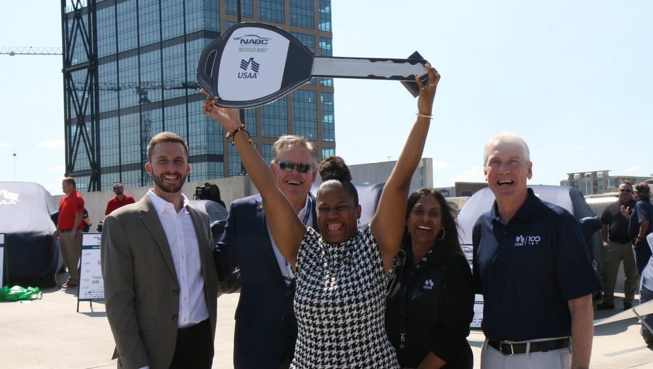 One of the winners holding up a key