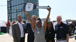 One of the winners holding up a key