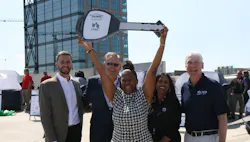 One of the winners holding up a key