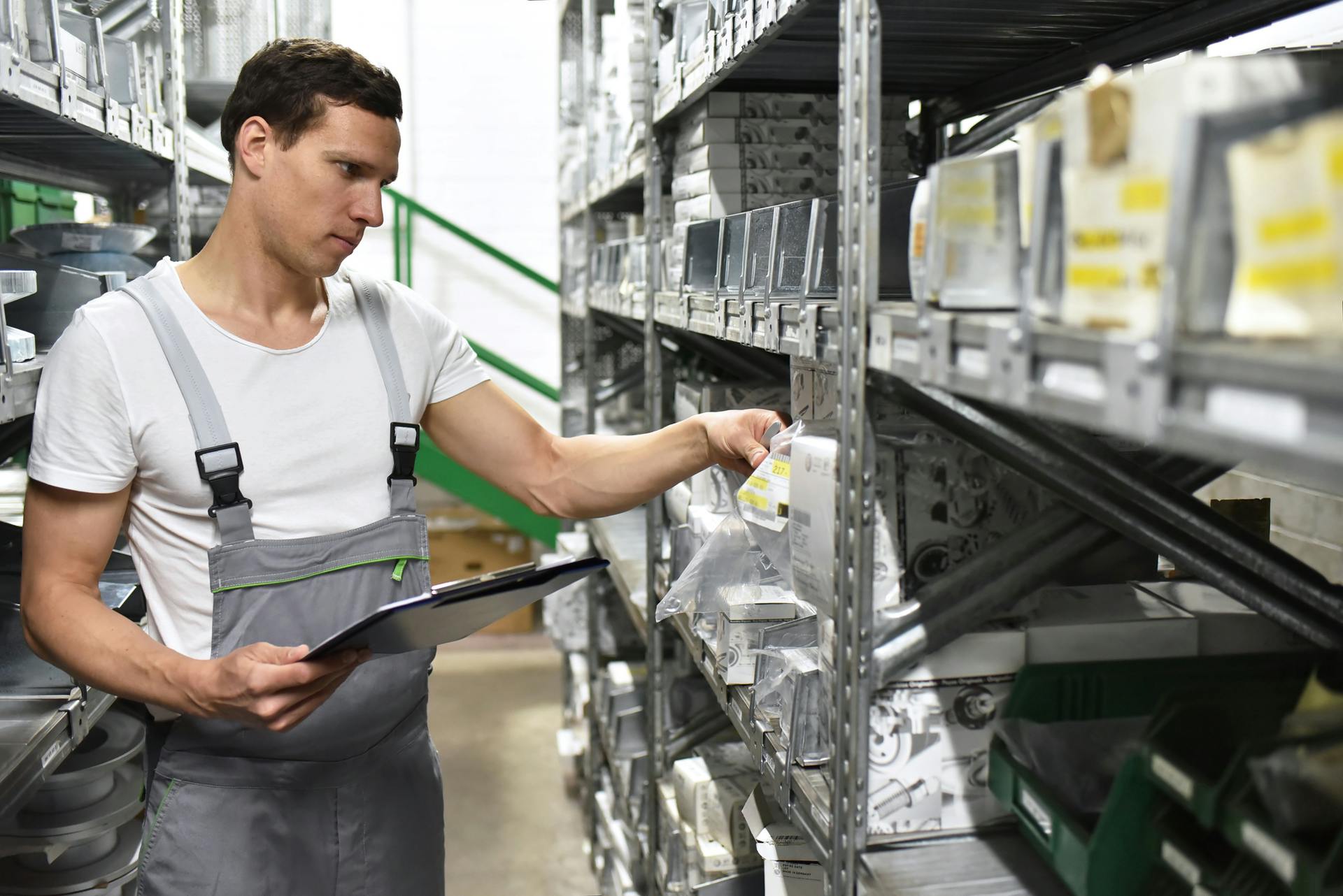 Young man in warehouse looking for car parts