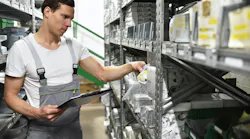 Young man in warehouse looking for car parts