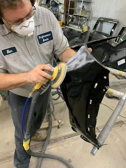 Figure 3 - Technician wears a respirator when sanding.
