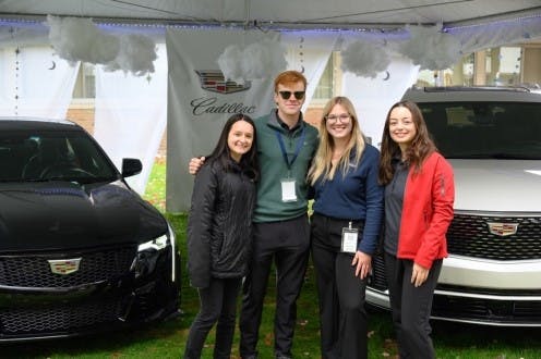 Northwood University students are pictured by the Cadillac display at the 2022 Northwood University International Auto Show.