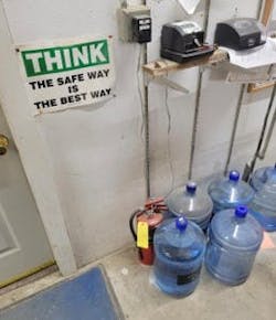 The fire extinguisher shown on the floor should be securely mounted to a wall bracket. The fire extinguisher shown on the floor should be securely mounted to a wall bracket.