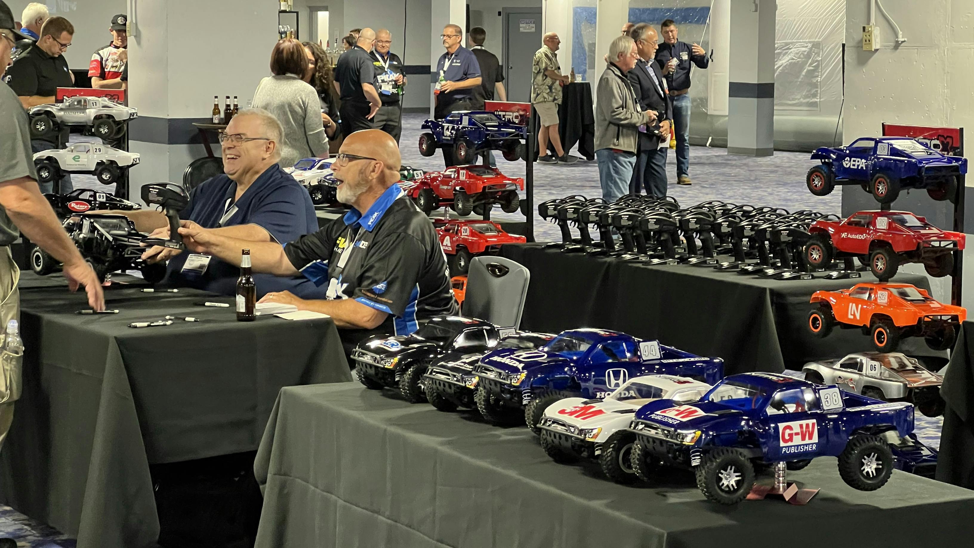 Instructors and other attendees hand out radio-control cars for test drives at the ASE Instructor Training Conference on Wednesday, July 17.