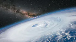 This stock image of a hurricane viewed from a NASA satellite shows the Milky Way galaxy at sunset.