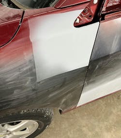 Primer surfacer applied after body repairs. While you want to reduce spreading the repair area to reduce color matching problems and overspray, don’t tape and mask off too close to the repair area intended to be covered as pictured. This can cause hard lines from the overspray or even running out of room to spray the surfaces leaving even harder lines. These will be hard to sand and block out risking showing up later in the painting process. Primer surfacer applied after body repairs. While you want to reduce spreading the repair area to reduce color matching problems and overspray, don’t tape and mask off too close to the repair area intended to be covered as pictured. This can cause hard lines from the overspray or even running out of room to spray the surfaces leaving even harder lines. These will be hard to sand and block out risking showing up later in the painting process.