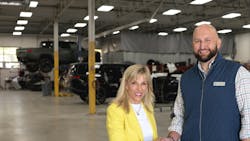 Jerod Guerin, CEO of QCG, shakes hands with Joanne LaMettry. Jerod Guerin, CEO of QCG, shakes hands with Joanne LaMettry.