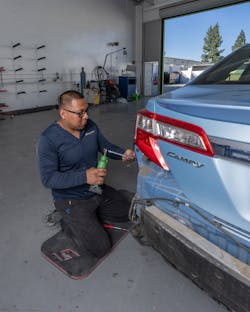 work_on_rear_of_car_with_tools work_on_rear_of_car_with_tools