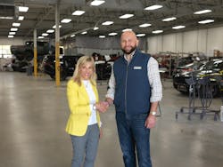 Jerod Guerin, CEO of QCG, shakes hands with Joanne LaMettry. Jerod Guerin, CEO of QCG, shakes hands with Joanne LaMettry.