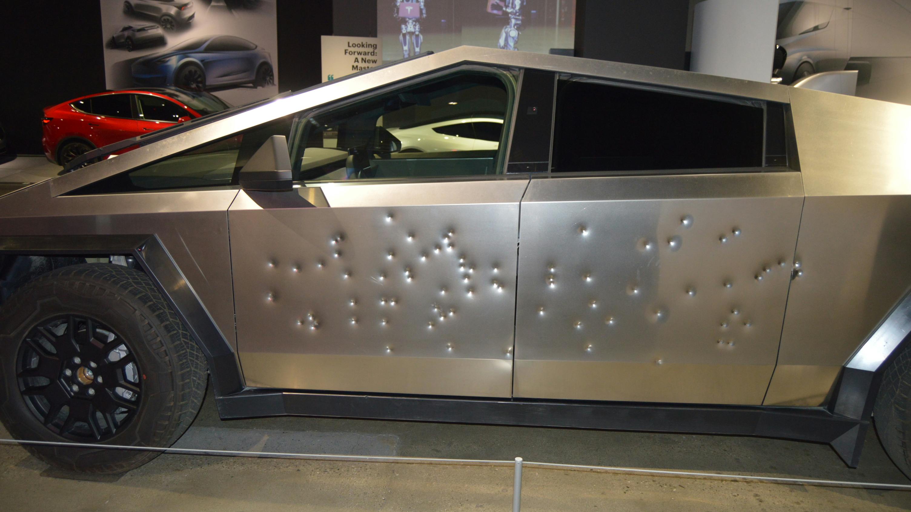 A 2024 Tesla Cybertruck on display at the Petersen Automotive Museum in Los Angeles in December 2023. The vehicle on display was shot with various weapons to demonstrate the strength of its exterior. Ballistics used included a .45 caliber 'Tommy Gun,' a 9mm Glock, a 9mm MP5-SD, and a 12-gauge shotgun. Five Tesla Cybertrucks at a Tesla Collision Center were damaged by fire and gunfire in Las Vegas on Tuesday, March 18.