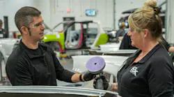 Application Engineer Specialist Ryan Marrinan discusses sandpaper selection with a student at the 3M Skills Development Center in St. Paul, Minnesota.
