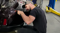 LEAD BY EXAMPLE: Showtime Collision Operator and Shop Manager Tyler Makeig assists with a fitment concern on a Subaru Outback. His hands-on leadership style is the foundation of the shop's culture.