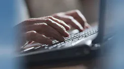 Hands on laptop keyboard