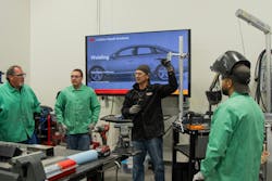 Marrinan demonstrates how technicians should set up overhead practice welds. Marrinan demonstrates how technicians should set up overhead practice welds.