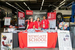Riley Estrada, Ivy Christensen, and Miselo Malana at the Newgate School booth provide information to visitors. Riley Estrada, Ivy Christensen, and Miselo Malana at the Newgate School booth provide information to visitors.