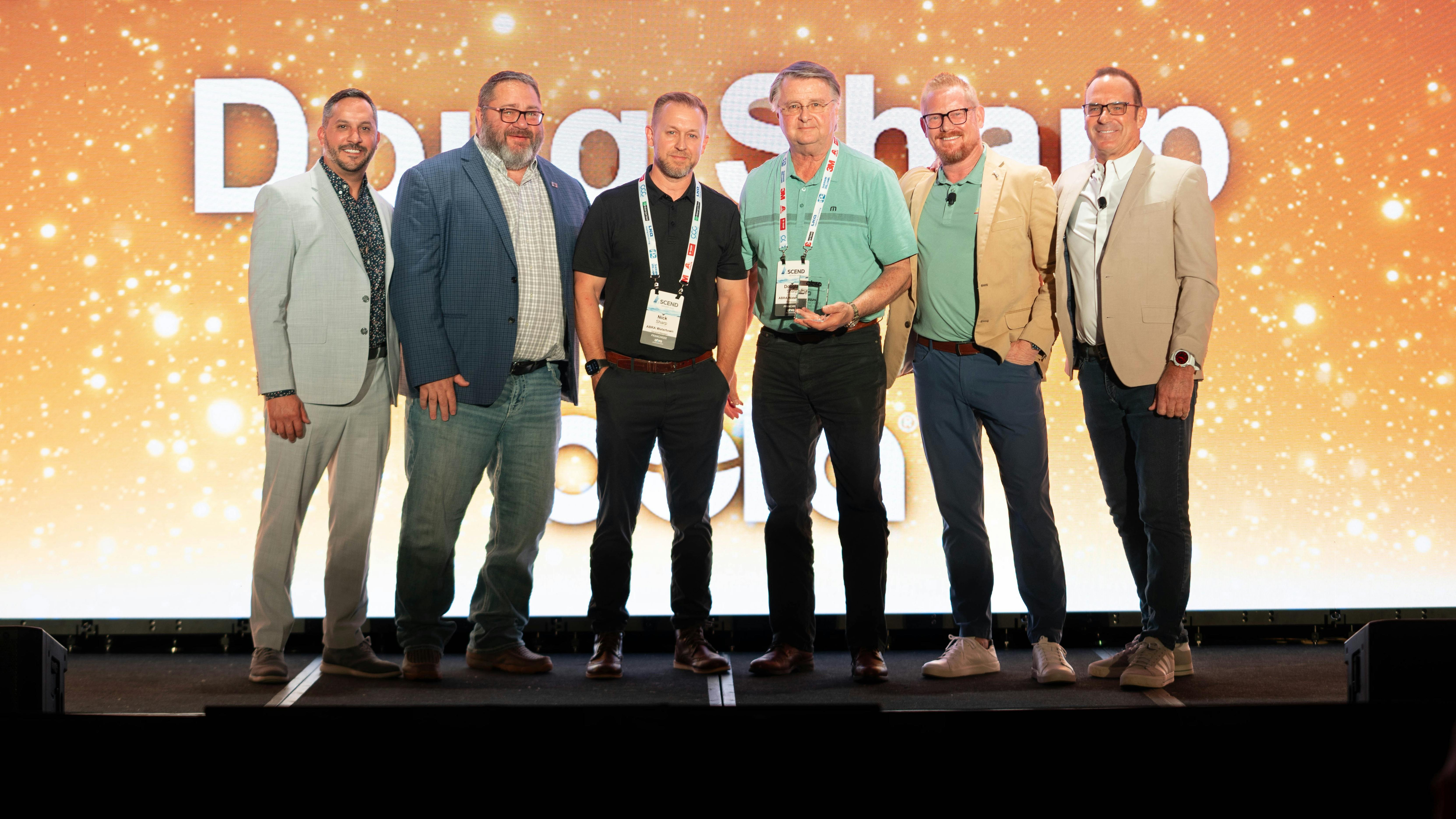 Doug Sharp, owner of Abra Watertown and Abra Brookings, wins Abra's 2025 Franchisee of the Year at the Ascend 2025 conference.