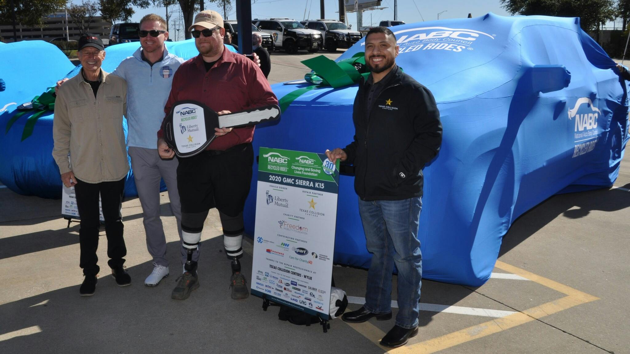 U.S. Marine Corps Veteran Ryan Zimmerer receives a 2020 GMC Sierra K1500 on Tuesday, Nov. 11, as part of a special ceremony by the National Auto Body Council.