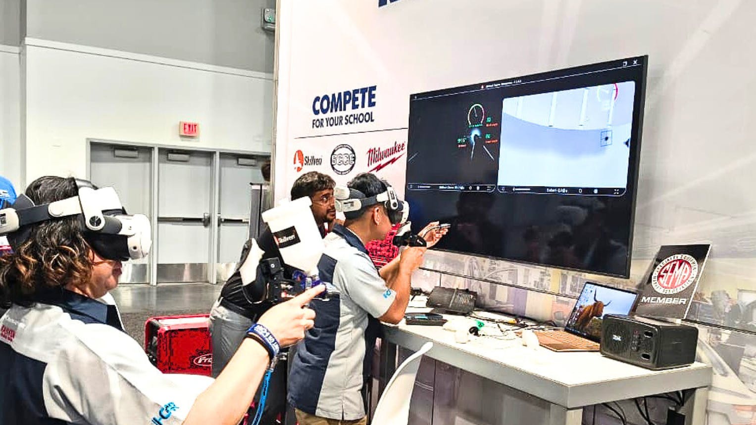 READY PAINTER ONE: Attendees at the 2025 SEMA Show try to set the high score in Skillveri's refinish simulator at the Society of Collision Repair Specialists booth.