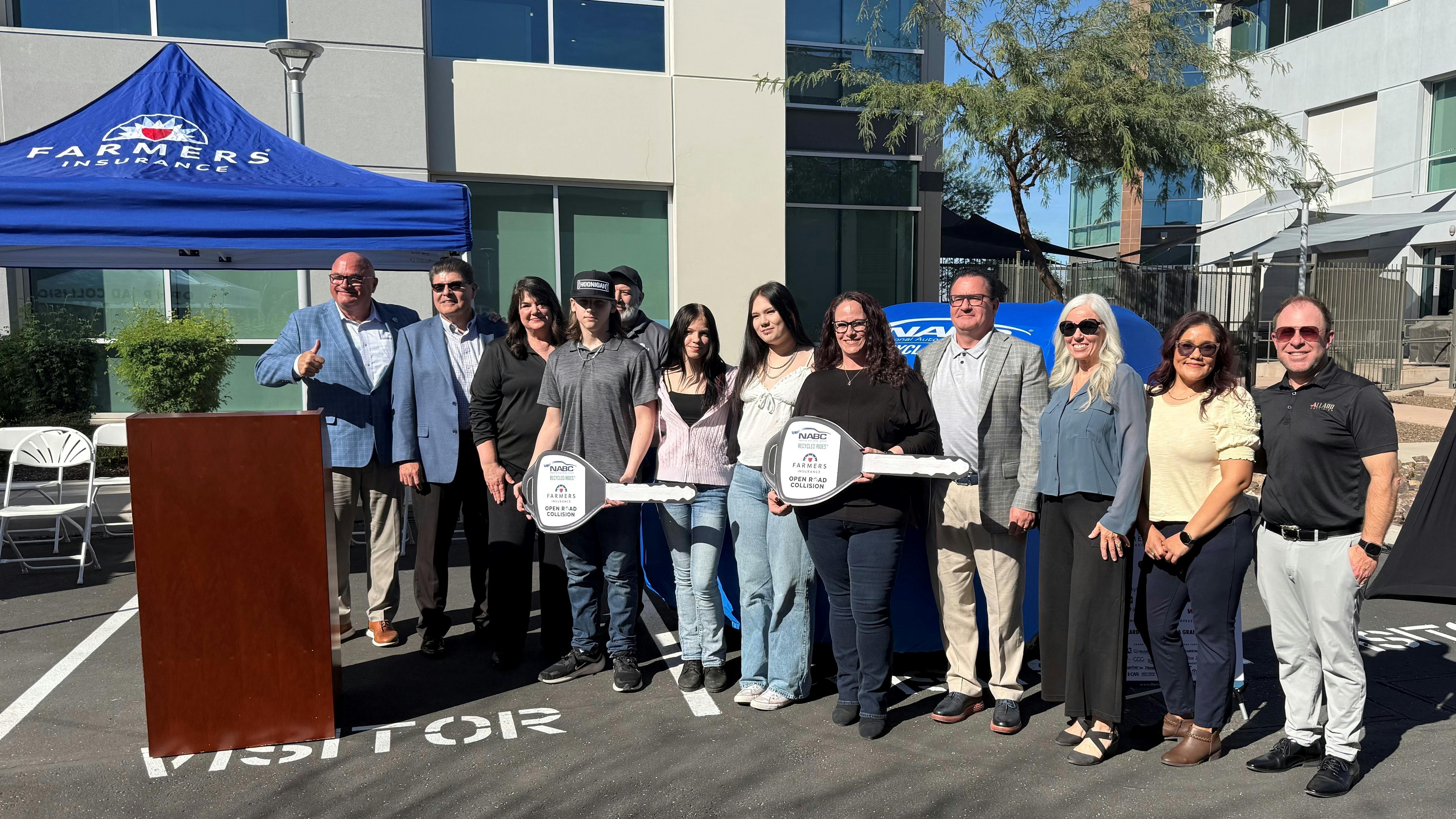 Sara Holman received a refurbished 2020 Nissan Morano from the National Auto Body Council Recycled Rides Program at the Farmers Insurance office in Phoenix, Arizona, on February 26.