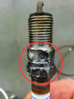 Figure 4: This is a spark plug from a second-gen Ford Super Duty V10. The customer had been complaining of a misfire. As can be seen from the plug, it had been experiencing carbon tracking for an extended period. The fix did not end at a spark plug replacement; the cylinder head was also collateral damage in this misfire, and the arcing opened a hole into the coolant passage. Once the root cause is found, checking for secondary problems is a must. Figure 4: This is a spark plug from a second-gen Ford Super Duty V10. The customer had been complaining of a misfire. As can be seen from the plug, it had been experiencing carbon tracking for an extended period. The fix did not end at a spark plug replacement; the cylinder head was also collateral damage in this misfire, and the arcing opened a hole into the coolant passage. Once the root cause is found, checking for secondary problems is a must.