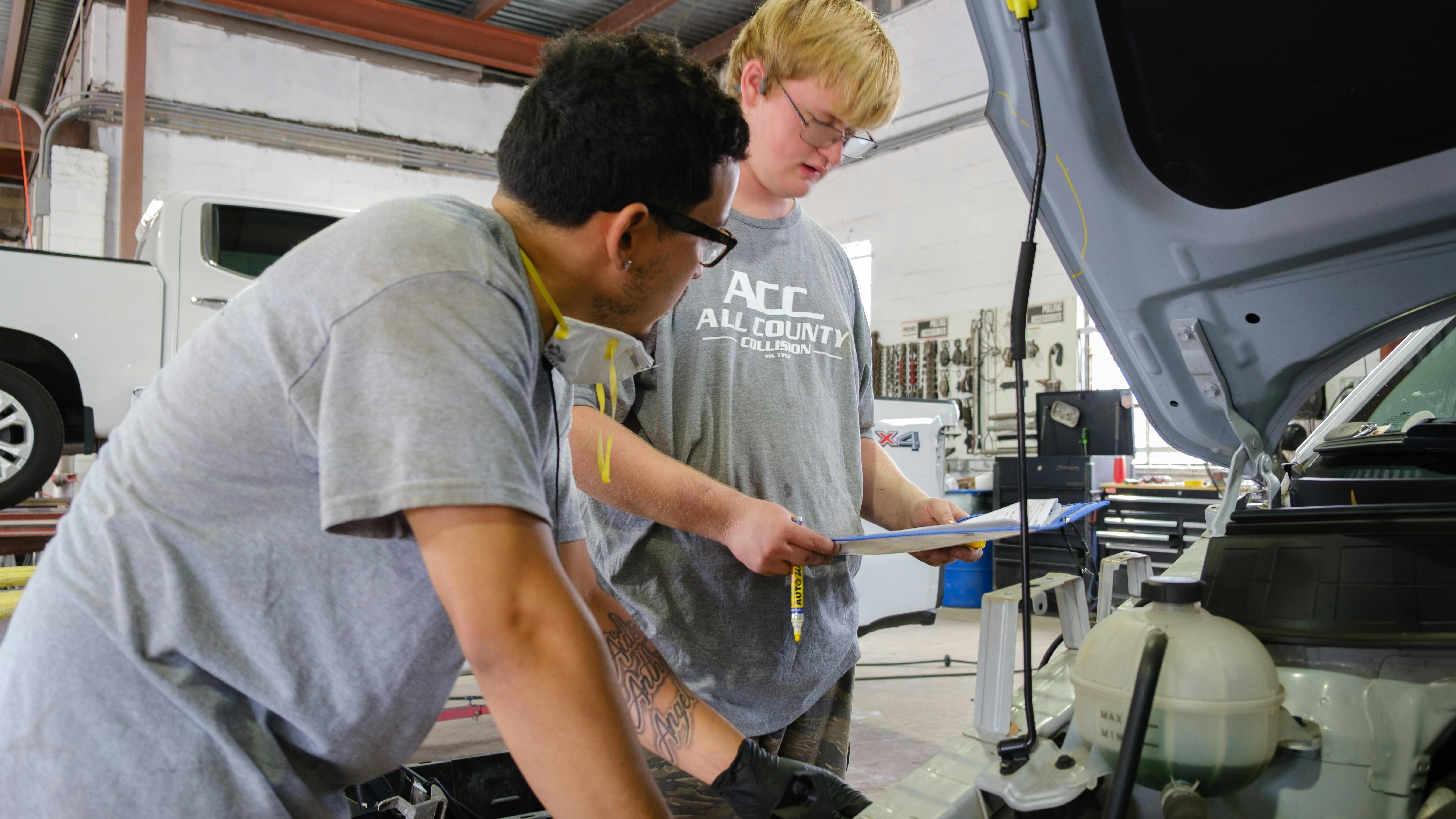 PRODUCTIVE APPRENTICESHIPS: At All County Collision, less-experienced team members, such as Aidan Richardson (r.) take on foundational tasks under close supervision.