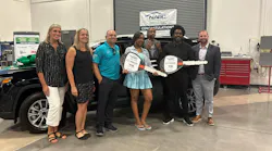 Raymond Auto Body Owner Jason Slomkowski (third from left) helps present a refurbished vehicle to U.S. Army veteran DiQuan Sanders.