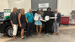 Raymond Auto Body Owner Jason Slomkowski (third from left) helps present a refurbished vehicle to U.S. Army veteran DiQuan Sanders.