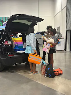 A trunk full of donations from Raymond Auto Body was presented to DiQuan Sanders and his family alongside their refurbished vehicle.